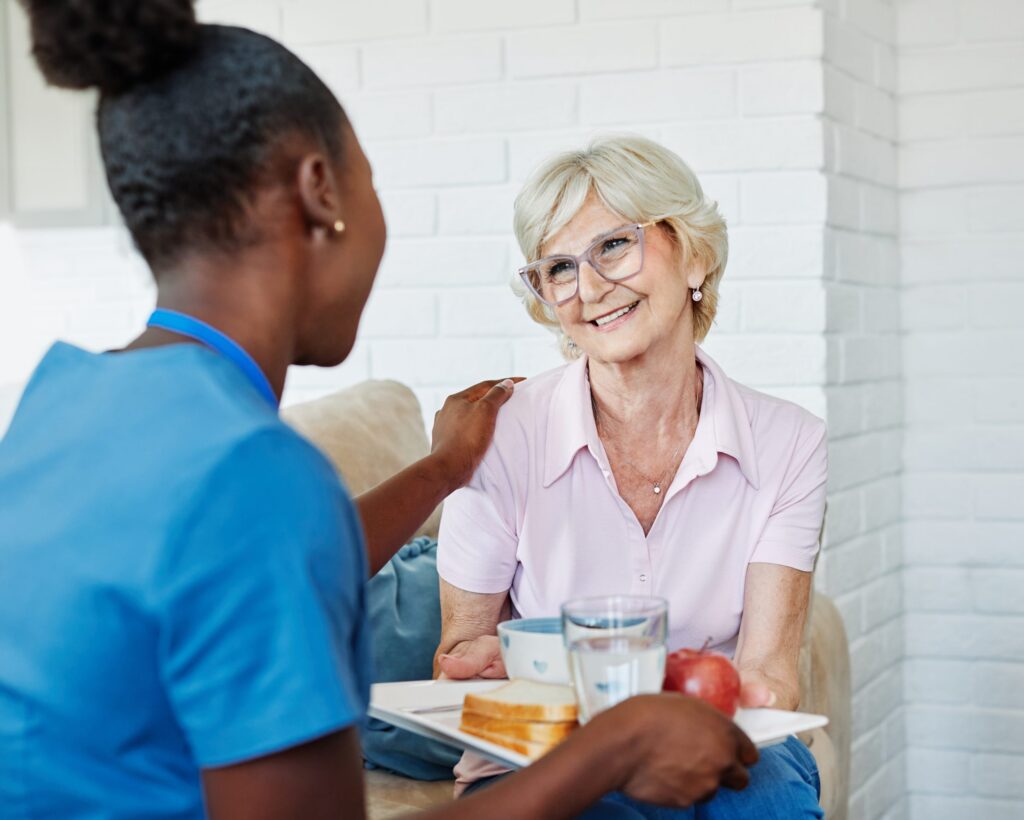 Smiling in-home caregiver in La Mesa, CA assisting senior with daily activities
